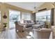 Comfortable living room with plush seating, natural light, and views of the outdoor pool area at 13791 Palmetto Point Ct, Port Charlotte, FL 33953