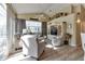 Sunlit living room with vaulted ceilings, neutral furniture, and a large window at 13791 Palmetto Point Ct, Port Charlotte, FL 33953