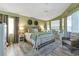 Tranquil main bedroom suite with ample natural light, cozy furnishings, and a peaceful view at 13791 Palmetto Point Ct, Port Charlotte, FL 33953