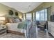 Serene main bedroom with cozy textures and light, featuring a sitting area and access to the outdoor patio at 13791 Palmetto Point Ct, Port Charlotte, FL 33953