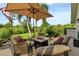 Relaxing outdoor patio featuring comfortable seating, a fire pit, and views of lush landscaping at 13791 Palmetto Point Ct, Port Charlotte, FL 33953