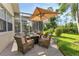 Patio with seating, umbrella, and view of the pool at 13791 Palmetto Point Ct, Port Charlotte, FL 33953