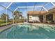 Screened pool area with patio and lush landscaping at 13791 Palmetto Point Ct, Port Charlotte, FL 33953