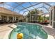 Screen enclosed pool features clear water and patio furniture at 13791 Palmetto Point Ct, Port Charlotte, FL 33953