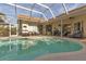 Large screened pool with patio and seating at 13791 Palmetto Point Ct, Port Charlotte, FL 33953