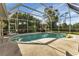 Inviting screened pool with patio furniture at 13791 Palmetto Point Ct, Port Charlotte, FL 33953