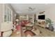 Comfortable living room with red couches, a ceiling fan and wood-look tile floors at 13808 Posada St, Venice, FL 34293