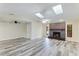 Bright living room with vaulted ceiling, fireplace, and wood-look flooring at 1535 Bay Hill Cir, Sarasota, FL 34232