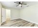 Bedroom with wood-look floors and ceiling fan at 1535 Bay Hill Cir, Sarasota, FL 34232