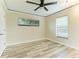 Well-lit bedroom featuring wood-look floors and ceiling fan at 1535 Bay Hill Cir, Sarasota, FL 34232