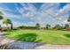 Expansive green lawn with string lights and walkway at 5227 Morey Farms Loop, Palmetto, FL 34221