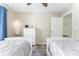 Spacious bedroom featuring two twin beds, a dresser, and a ceiling fan at 4525 46Th Street W Ct # 201B, Bradenton, FL 34210