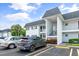 Front view of the condo building with parked cars and landscaped shrubs at 304 47Th Avenue W Dr # 307, Bradenton, FL 34207