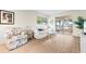 Living room with wood-look flooring, comfortable seating, and natural light at 304 47Th Avenue W Dr # 307, Bradenton, FL 34207