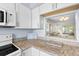 Kitchen with granite counters, white cabinets, and a pass-through window at 304 47Th Avenue W Dr # 307, Bradenton, FL 34207