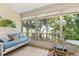 Bright sunroom with wicker furniture and large windows overlooking lush greenery at 304 47Th Avenue W Dr # 307, Bradenton, FL 34207