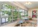 Spacious sunroom with wicker chairs, glass table, and scenic views at 304 47Th Avenue W Dr # 307, Bradenton, FL 34207