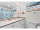 Modern bathroom featuring white cabinetry, granite countertop, and decorative accents at 304 47Th Avenue W Dr # 307, Bradenton, FL 34207