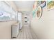 Hallway leading to the kitchen, featuring white cabinets and artwork at 304 47Th Avenue W Dr # 307, Bradenton, FL 34207