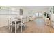 Open living and dining area with wood-look flooring and access to the balcony at 304 47Th Avenue W Dr # 307, Bradenton, FL 34207