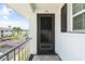 Condo entrance with a screened door and balcony overlooking the parking area at 304 47Th Avenue W Dr # 307, Bradenton, FL 34207