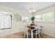 Dining area with wood-look flooring, a white table, and chairs at 304 47Th Avenue W Dr # 307, Bradenton, FL 34207