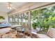 Inviting sunroom with wicker furniture, daybed, and views of nature at 304 47Th Avenue W Dr # 307, Bradenton, FL 34207