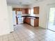 Galley kitchen with wood cabinets, tiled floor, and appliances at 6209 Flagfish Ct, Lakewood Ranch, FL 34202