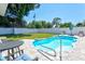 Inviting kidney shaped pool with patio furniture in a fenced backyard at 5936 Albert Pl, Sarasota, FL 34231