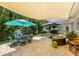 Spacious patio with seating areas, umbrellas, and shade sail at 111 49Th St, Holmes Beach, FL 34217