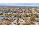 Wide aerial view of a residential area with waterfront homes and mature trees under a blue sky at 2232 River Ridge Dr, Sarasota, FL 34239