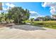 Concrete patio overlooking a waterway with green landscaping and backyard seating at 2232 River Ridge Dr, Sarasota, FL 34239