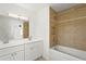 Inviting bathroom with a shower and tub combination and a dual sink vanity with great lighting at 2232 River Ridge Dr, Sarasota, FL 34239
