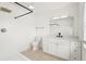 Bright bathroom features a modern vanity, a shower with black hardware, and tiled floor at 2232 River Ridge Dr, Sarasota, FL 34239