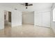 Spacious bedroom boasts a ceiling fan, large closet, and tiled floors leading to ensuite bathroom at 2232 River Ridge Dr, Sarasota, FL 34239