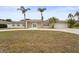 Inviting single-story home with a two-car garage, elegant white double door entrance, and a circular driveway at 2232 River Ridge Dr, Sarasota, FL 34239