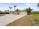 Single-story home with an attached two-car garage, circular driveway, and well-maintained lawn at 2232 River Ridge Dr, Sarasota, FL 34239