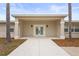 Inviting home entrance featuring double doors, neutral tones, and landscaping at 2232 River Ridge Dr, Sarasota, FL 34239