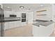 Well-equipped kitchen showcasing white cabinetry, stainless steel appliances, and counter space at 2232 River Ridge Dr, Sarasota, FL 34239