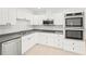 Updated kitchen features stainless steel appliances, white cabinets, and ample counter space at 2232 River Ridge Dr, Sarasota, FL 34239