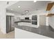 Modern kitchen featuring white cabinets, stainless steel appliances, and a countertop breakfast bar at 2232 River Ridge Dr, Sarasota, FL 34239