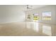 Open living space with tile floors, large sliding glass doors, and neutral colors at 2232 River Ridge Dr, Sarasota, FL 34239