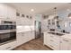 Modern kitchen with white cabinets, stainless steel appliances, and ample counter space at 1200 Via Tripoli, Punta Gorda, FL 33950
