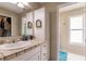 Bathroom with single sink vanity, tiled countertop and linen closet at 1200 Via Tripoli, Punta Gorda, FL 33950