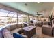 Relaxing lanai with sectional sofa, fire pit table, and pool view at 1200 Via Tripoli, Punta Gorda, FL 33950