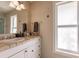 Guest bathroom with single sink vanity, tiled countertop and large window at 1200 Via Tripoli, Punta Gorda, FL 33950