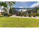 Landscaped backyard with screened enclosure and lush greenery at 1200 Via Tripoli, Punta Gorda, FL 33950