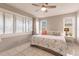 Bright bedroom featuring a king-size bed and window seating at 1200 Via Tripoli, Punta Gorda, FL 33950