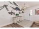 Coastal-themed entryway with decorative fish wall art and console table at 1200 Via Tripoli, Punta Gorda, FL 33950
