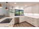 Bright kitchen boasting white cabinets, stainless steel appliances, and a view to the backyard at 1200 Via Tripoli, Punta Gorda, FL 33950
